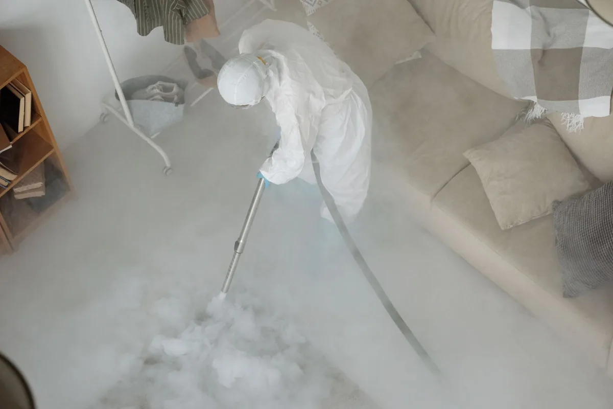 Biohazard cleanup technician in protective equipment, Blue Earth, MN